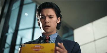 Image of Blue Beetle star holding a package.