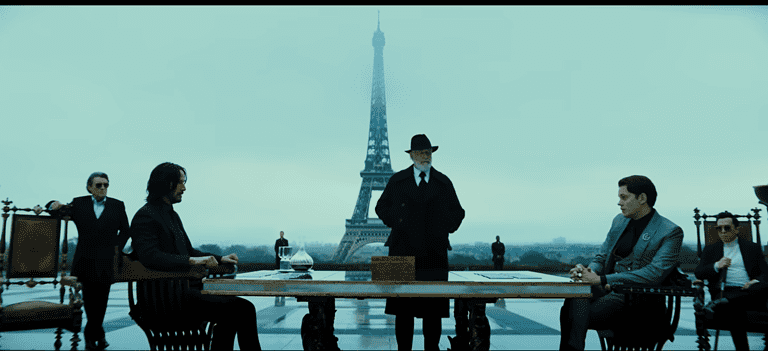 Image of John Wick seated opposite the antagonist of John Wick: Chapter 4.